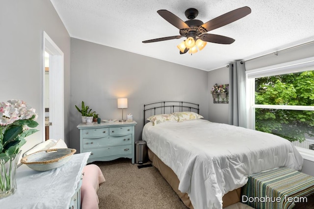 bedroom featuring carpet floors, a textured ceiling, and ceiling fan