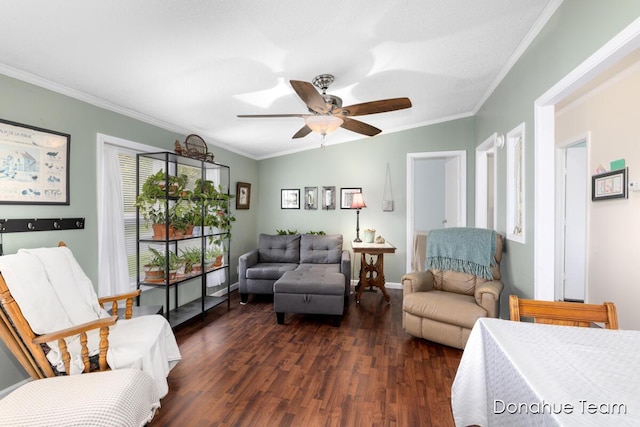 living area featuring ornamental molding, dark wood-style floors, a ceiling fan, and baseboards