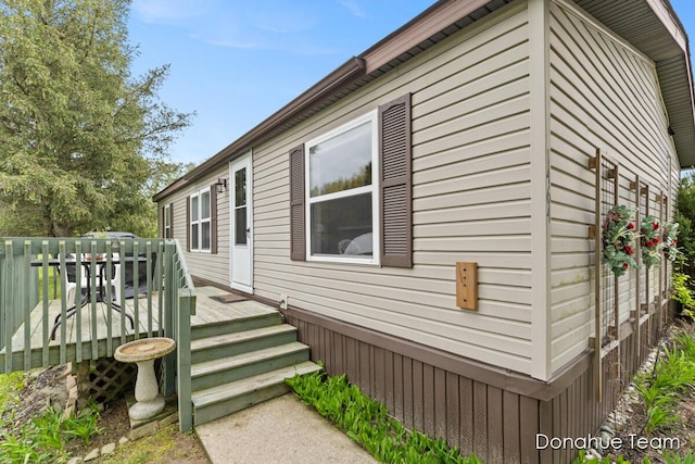 view of home's exterior featuring a wooden deck