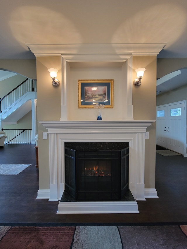 10726 Davisburg Rd, Davisburg, MI 48350 - detailed view of a warm lit fireplace, baseboards, arched walkways, and wood finished floors