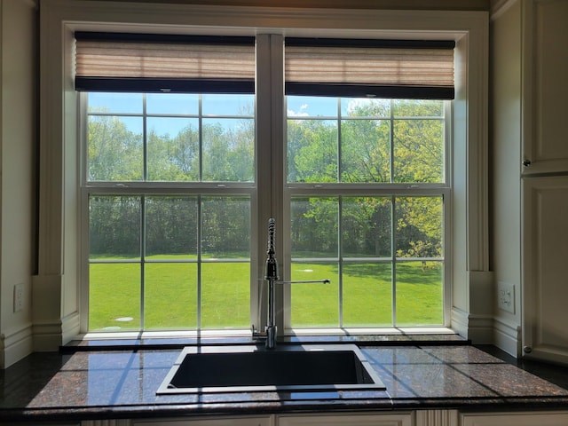 10726 Davisburg Rd, Davisburg, MI 48350 - kitchen view of a sink, tile counters, and baseboards