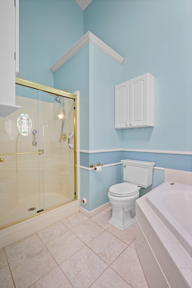 bathroom with a shower stall, tile patterned floors, toilet, and baseboards