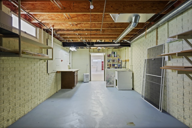 basement featuring brick wall