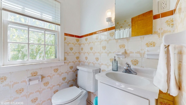 1200 Mohawk Ln, Saint Joseph, MI 49085 - bathroom with tile walls, vanity, and toilet