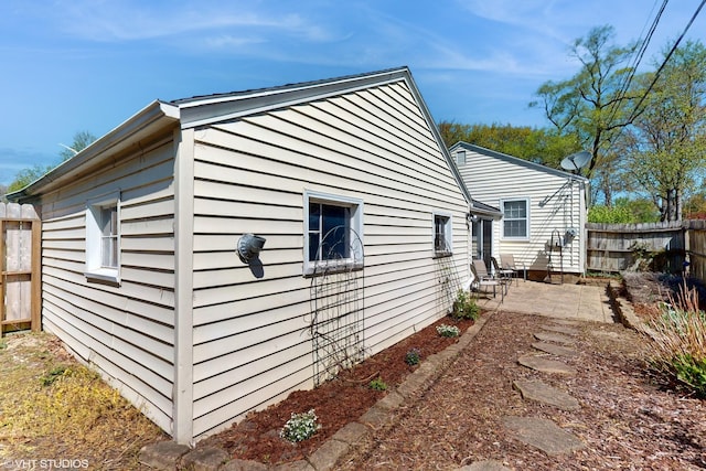 1200 Mohawk Ln, Saint Joseph, MI 49085 - view of side of property featuring fence and a patio area