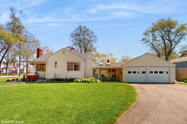 1200 Mohawk Ln, Saint Joseph, MI 49085 - view of front facade with covered porch, driveway, a chimney, a garage, and solar panels