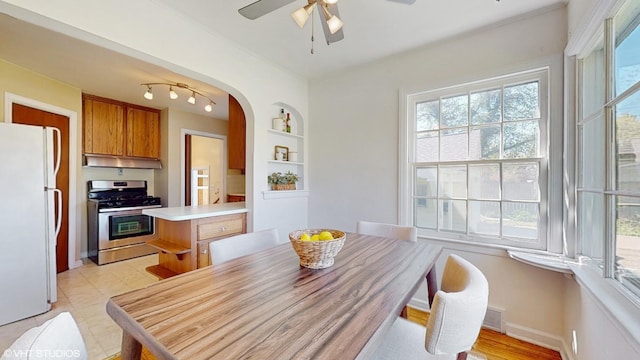 1200 Mohawk Ln, Saint Joseph, MI 49085 - dining area with ceiling fan, arched walkways, built in features, and baseboards