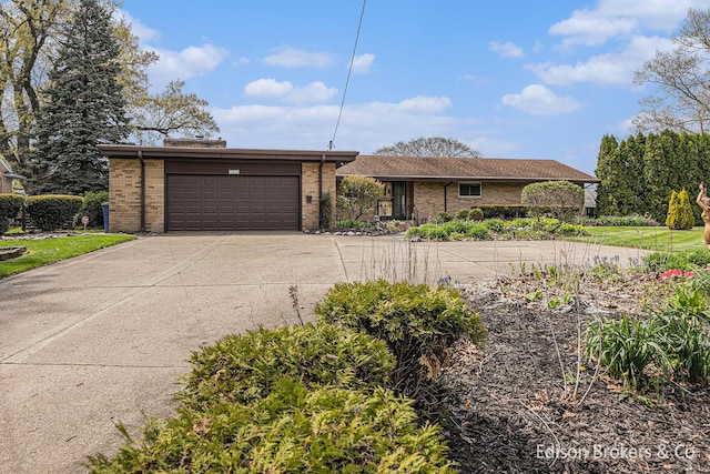 1657 W Kentview Dr NE, Grand Rapids, MI 49505 - view of front of property with concrete driveway, brick siding, and a garage