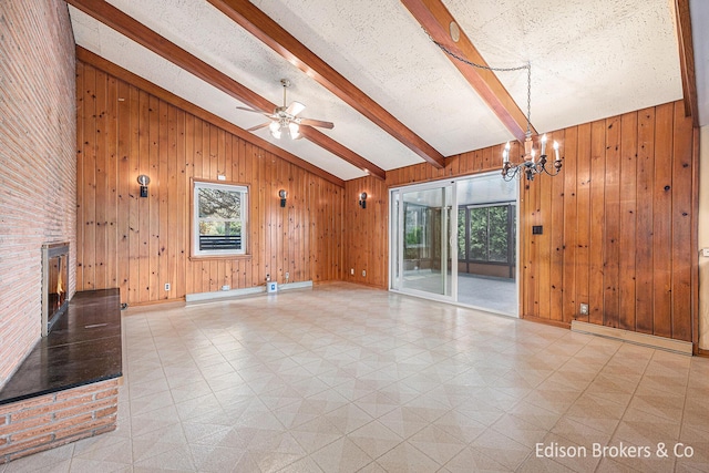 1657 W Kentview Dr NE, Grand Rapids, MI 49505 - unfurnished living room featuring light flooring, a chandelier, a brick fireplace, wooden walls, and ceiling fan