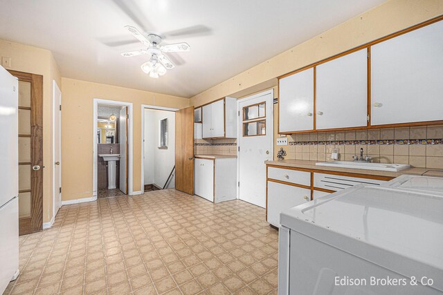 1657 W Kentview Dr NE, Grand Rapids, MI 49505 - kitchen featuring a sink, light flooring, ceiling fan, light countertops, and white cabinets