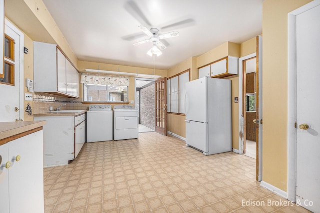 1657 W Kentview Dr NE, Grand Rapids, MI 49505 - kitchen with freestanding refrigerator, separate washer and dryer, ceiling fan, light countertops, and a sink