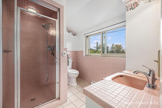 1657 W Kentview Dr NE, Grand Rapids, MI 49505 - bathroom with tile patterned floors, a sink, lofted ceiling, tile walls, and a shower stall