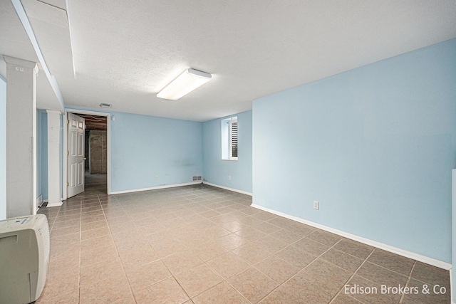 1657 W Kentview Dr NE, Grand Rapids, MI 49505 - below grade area featuring baseboards, a textured ceiling, and heating unit