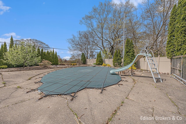 1657 W Kentview Dr NE, Grand Rapids, MI 49505 - view of pool with a water slide, fence, and a patio area