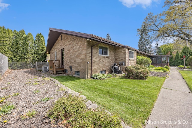 1657 W Kentview Dr NE, Grand Rapids, MI 49505 - view of side of home featuring a sunroom, brick siding, and cooling unit