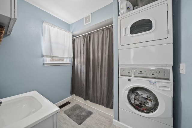 443 S Jackson St, Hanover, MI 49241 - washroom with stacked washer / drying machine, baseboards, and wood finished floors