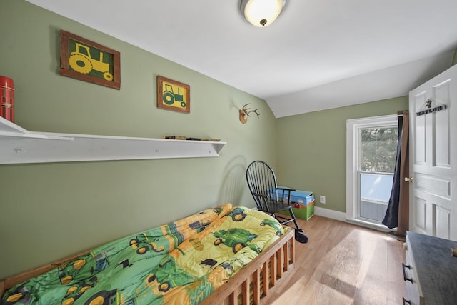 443 S Jackson St, Hanover, MI 49241 - bedroom with light wood-style flooring, vaulted ceiling, and baseboards
