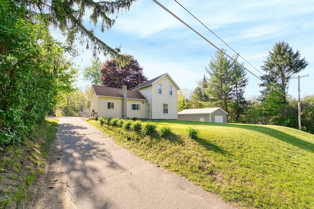 443 S Jackson St, Hanover, MI 49241 - view of property exterior featuring a yard and a detached garage