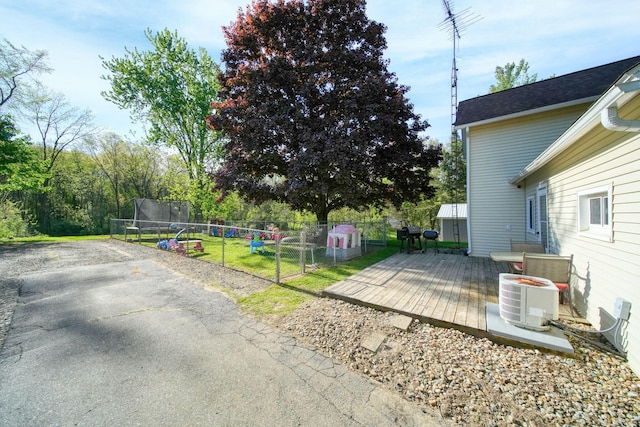443 S Jackson St, Hanover, MI 49241 - view of yard with a trampoline, a wooden deck, a gate, and central AC unit