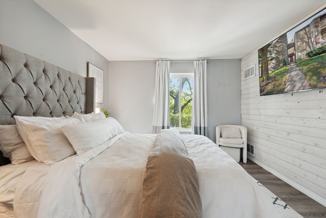 9601 Bayview Dr # 301, Ypsilanti, MI 48197 - bedroom featuring wood finished floors, baseboards, and wooden walls