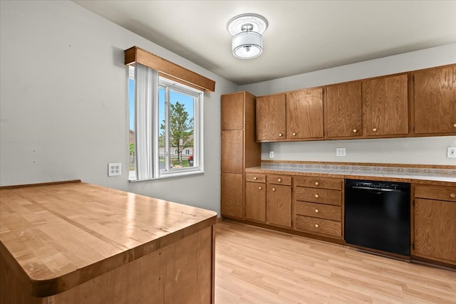 kitchen with dishwasher, brown cabinets, light wood-style flooring, and a peninsula