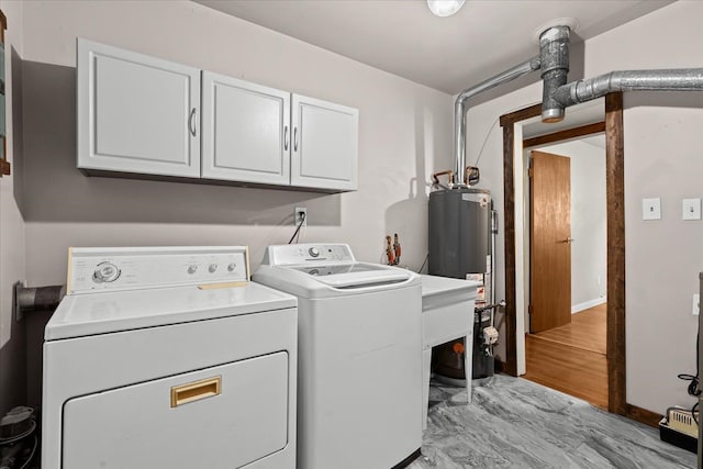 laundry area with cabinet space, washer and dryer, and gas water heater