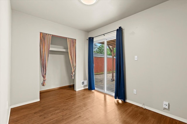 empty room with wood finished floors and baseboards