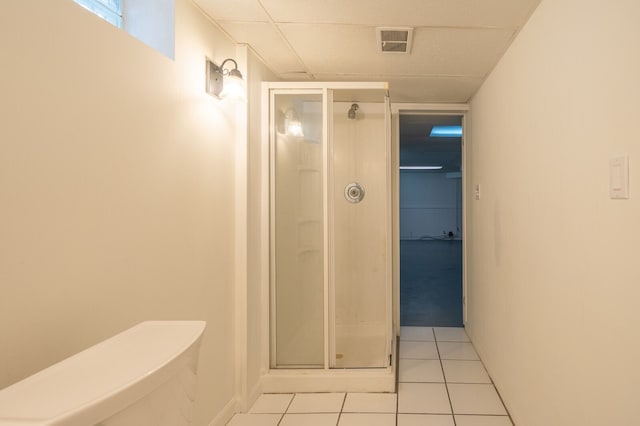 full bath with a shower stall and tile patterned floors