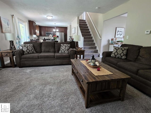 465 Edgewood Pass, Fenton, MI 48430 - living room featuring carpet, stairs, and a chandelier