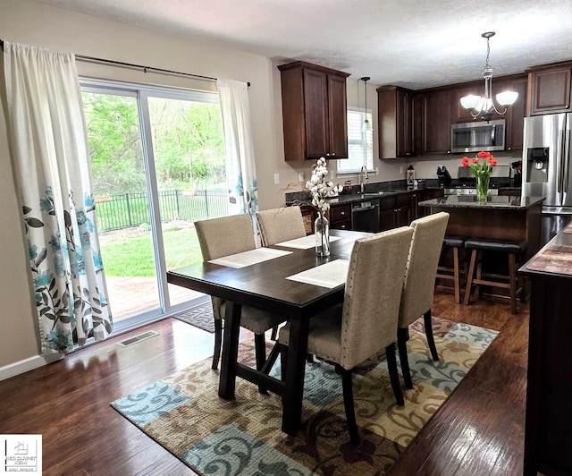 465 Edgewood Pass, Fenton, MI 48430 - dining area with dark wood-type flooring and a chandelier