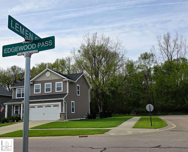 465 Edgewood Pass, Fenton, MI 48430 - exterior view of concrete driveway and a downspout