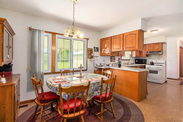 3480 S Vassar Rd, Burton, MI 48519 - dining space with a chandelier and baseboards
