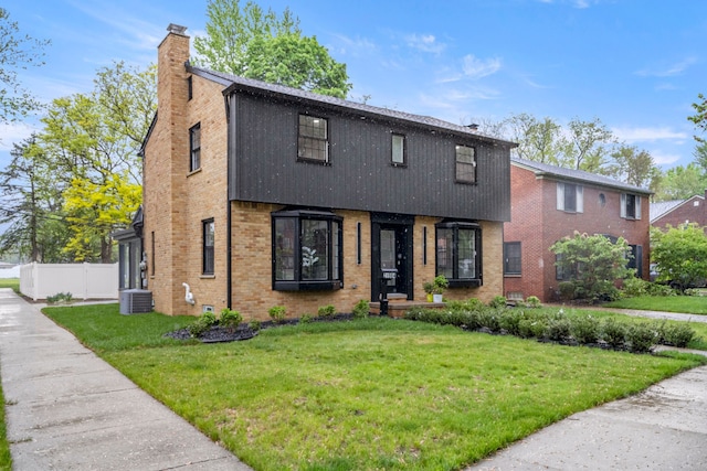 21984 Wildwood St, Dearborn, MI 48128 - colonial inspired home featuring a chimney, brick siding, and central AC