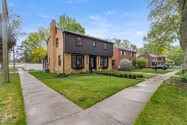 21984 Wildwood St, Dearborn, MI 48128 - view of front of home featuring a chimney, central AC unit, and brick siding