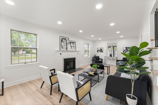 21984 Wildwood St, Dearborn, MI 48128 - living area with a fireplace with flush hearth, light wood finished floors, recessed lighting, and baseboards