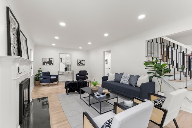 21984 Wildwood St, Dearborn, MI 48128 - living area featuring a fireplace with flush hearth, light wood finished floors, stairs, recessed lighting, and baseboards