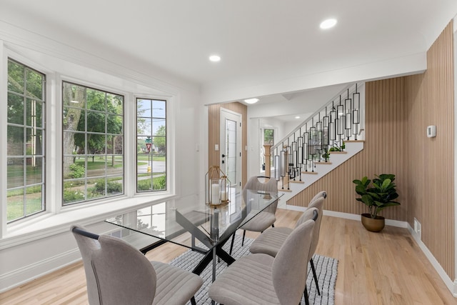 21984 Wildwood St, Dearborn, MI 48128 - dining space with baseboards, light wood-type flooring, stairway, recessed lighting, and wood walls