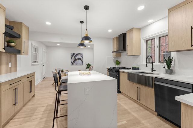 21984 Wildwood St, Dearborn, MI 48128 - kitchen featuring black range with gas cooktop, wall chimney range hood, dishwasher, light brown cabinetry, and recessed lighting