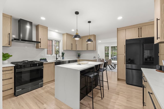 21984 Wildwood St, Dearborn, MI 48128 - kitchen with black appliances, wall chimney exhaust hood, light brown cabinetry, and recessed lighting