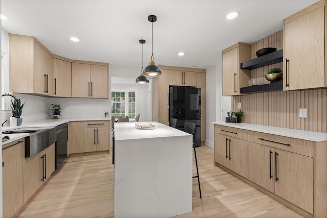 21984 Wildwood St, Dearborn, MI 48128 - kitchen featuring light brown cabinetry, black appliances, open shelves, light wood finished floors, and a kitchen island