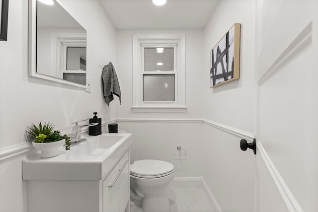 21984 Wildwood St, Dearborn, MI 48128 - half bathroom with toilet, marble look tile flooring, vanity, and baseboards