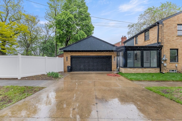 21984 Wildwood St, Dearborn, MI 48128 - view of front of home with brick siding, a garage, and fence