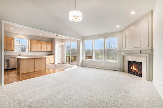 3736 Vicksburg Way, Howell, MI 48843 - unfurnished living room featuring a chandelier, recessed lighting, a tile fireplace, plenty of natural light, and light wood-type flooring