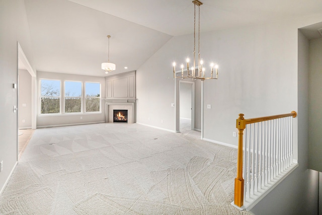 3736 Vicksburg Way, Howell, MI 48843 - unfurnished living room with vaulted ceiling, a chandelier, baseboards, light carpet, and a premium fireplace