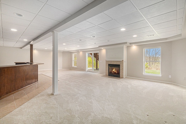 3736 Vicksburg Way, Howell, MI 48843 - below grade area with light colored carpet, baseboards, a tile fireplace, light tile patterned flooring, and recessed lighting