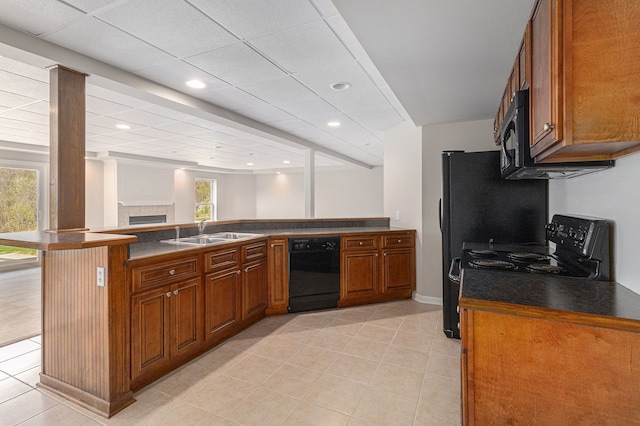 3736 Vicksburg Way, Howell, MI 48843 - kitchen featuring black appliances, a sink, brown cabinets, dark countertops, and recessed lighting