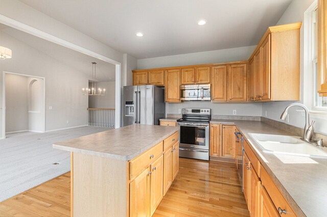 3736 Vicksburg Way, Howell, MI 48843 - kitchen with stainless steel appliances, a sink, a chandelier, light wood-type flooring, and vaulted ceiling