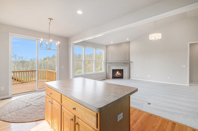 3736 Vicksburg Way, Howell, MI 48843 - kitchen featuring a chandelier, a fireplace, recessed lighting, a kitchen island, and open floor plan
