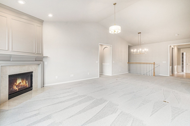 3736 Vicksburg Way, Howell, MI 48843 - unfurnished living room with vaulted ceiling, a high end fireplace, a chandelier, light colored carpet, and baseboards