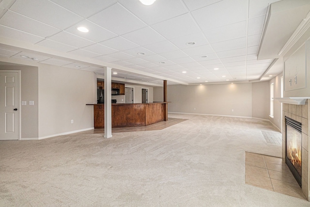 3736 Vicksburg Way, Howell, MI 48843 - unfurnished living room with light carpet, baseboards, a tile fireplace, recessed lighting, and a drop ceiling